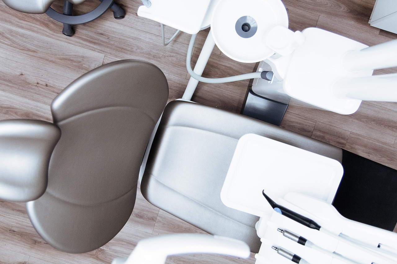 overhead view of a dentist chair and tool tray, sink