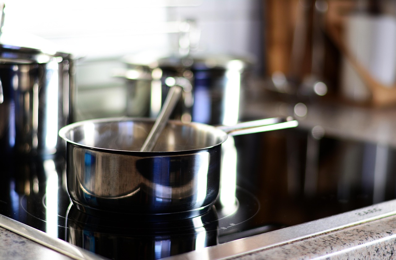stainless steel pots on a glass top stove