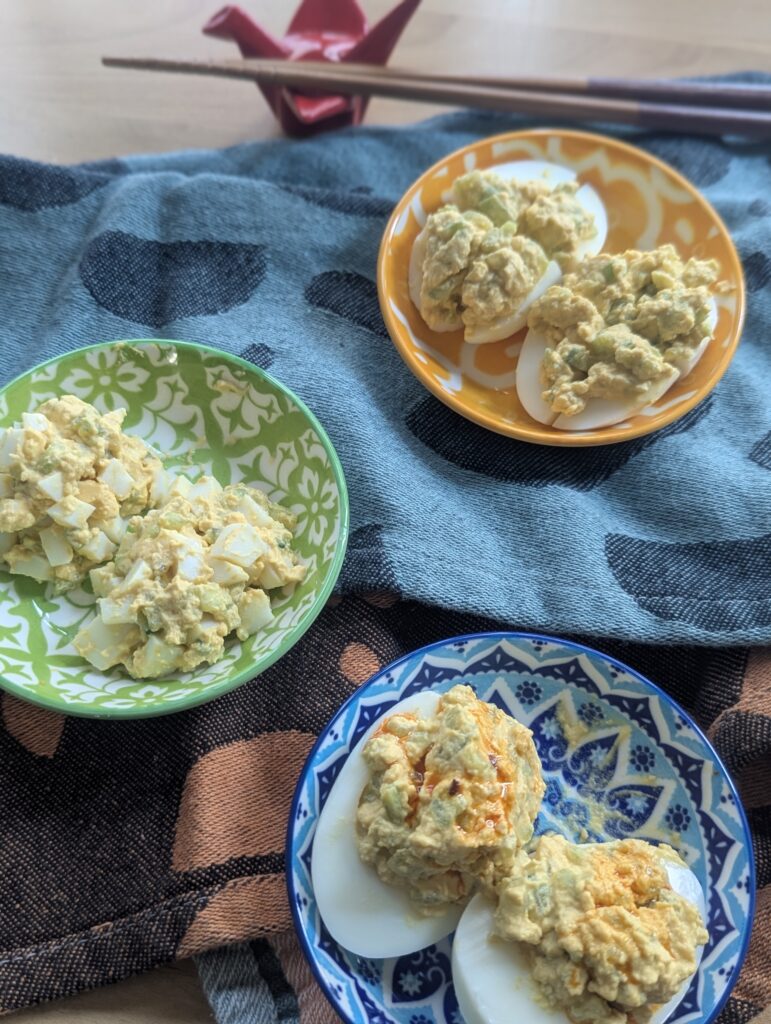 Sesame cucumber deviled eggs prepared for 3 different IDDSI levels: Minced & Moist (green), Soft & Bite-Sized (yellow), Easy to Chew (blue).